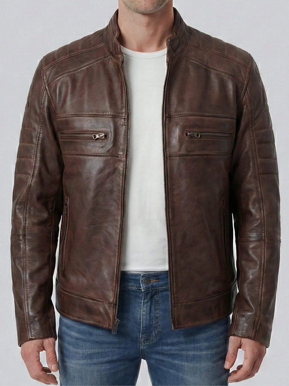 Brown leather jacket worn by a person on a plain background