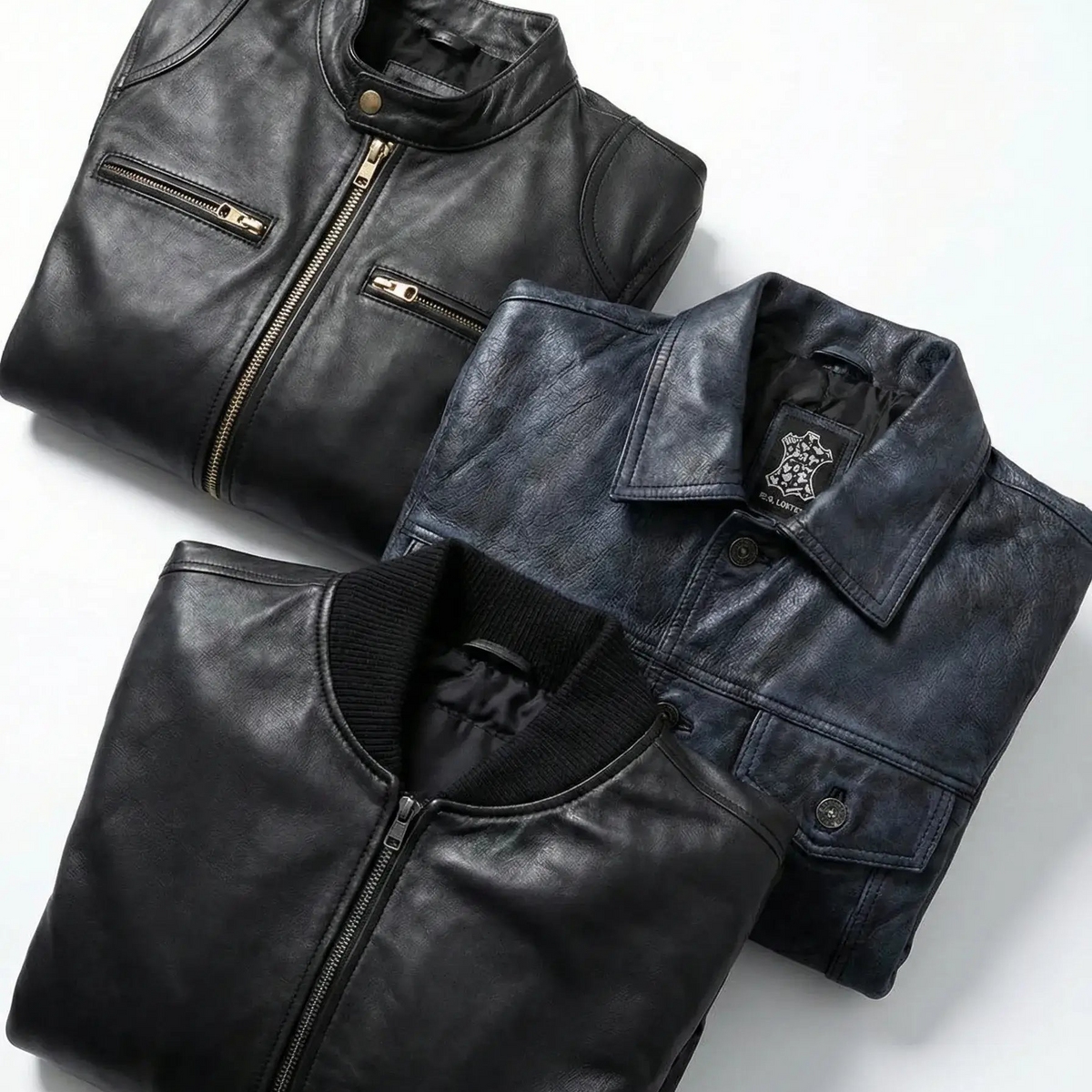 Three folded leather jackets on a light gray background